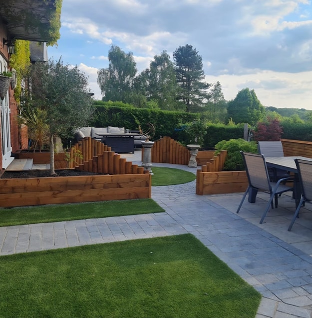 Professional landscaping with lawn, plants, and paved patio
